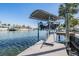 Covered boat lift offering seamless access to the canal, blending convenience with waterfront living at 4383 Biscayne Dr, Hernando Beach, FL 34607