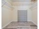 Organized walk-in closet with shelves, a shoe rack, and modern flooring at 4383 Biscayne Dr, Hernando Beach, FL 34607