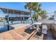 Waterfront dock with boat lift and outdoor dining space, perfect for enjoying the canal views and boating lifestyle at 4383 Biscayne Dr, Hernando Beach, FL 34607