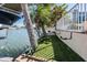 Green space next to a boat dock over looking the canal lined with trees and shrubs, adding natural beauty at 4383 Biscayne Dr, Hernando Beach, FL 34607