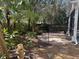 Landscaped backyard with tropical plants and a brick patio at 4425 Merrick Run Ln, Valrico, FL 33596