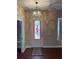 The entryway is adorned with a stained-glass front door and a modern chandelier at 4425 Merrick Run Ln, Valrico, FL 33596