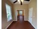 Open concept living area with red-tiled floors featuring large windows and an adjacent room at 4425 Merrick Run Ln, Valrico, FL 33596