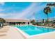 Sparkling community pool with ample lounge chairs and an American flag waving in the breeze at 4715 Bay Ne St # 126, St Petersburg, FL 33703