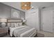 Well-lit bedroom showcasing closet, neutral tones, and stylish light fixture at 5018 Coastal Oak Ct, Lakewood Ranch, FL 34211