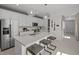 Bright kitchen featuring modern appliances, white cabinets and a breakfast bar at 5018 Coastal Oak Ct, Lakewood Ranch, FL 34211