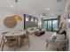 Modern living room with a dining table and views of the lake at 5018 Coastal Oak Ct, Lakewood Ranch, FL 34211