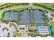 Aerial shot of tennis and pickleball courts nestled in lush landscaping with nearby parking and facilities for active community members at 5018 Coastal Oak Ct, Lakewood Ranch, FL 34211