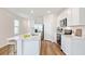 Stylish kitchen with a center island, stainless steel appliances and bright white cabinets at 5021 Rocky Coast Pl, Palmetto, FL 34221