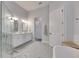 Bright bathroom with a glass shower and double sink vanity at 5318 Wishing Arch Dr, Apollo Beach, FL 33572