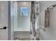 Bathroom featuring a tub with shower curtain, white tile, and a stainless towel rack at 5318 Wishing Arch Dr, Apollo Beach, FL 33572