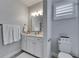 Cozy bathroom featuring a vanity with white cabinets and drawers and a comfort height toilet at 5318 Wishing Arch Dr, Apollo Beach, FL 33572