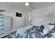 Stylish bedroom with ceiling fan, large windows, modern decor, and modern nautical bedding at 5318 Wishing Arch Dr, Apollo Beach, FL 33572