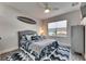 Charming bedroom featuring nautical decor, a ceiling fan, and large window views at 5318 Wishing Arch Dr, Apollo Beach, FL 33572