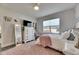 Charming bedroom with pink accents, decorative lighting, and modern gray wood floors at 5318 Wishing Arch Dr, Apollo Beach, FL 33572