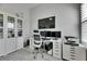 Modern home office setup with large monitor, ideal for focused work and productivity at 5318 Wishing Arch Dr, Apollo Beach, FL 33572