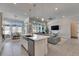 Bright, open-concept kitchen with an island, stainless steel appliances, and a view of the dining and living areas at 5318 Wishing Arch Dr, Apollo Beach, FL 33572