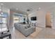 Living room featuring a sectional sofa, entertainment center, and sliding glass doors to the outdoor area at 5318 Wishing Arch Dr, Apollo Beach, FL 33572
