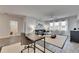 Bright living space featuring an office area, ceiling fan, and modern gray wood floors at 5318 Wishing Arch Dr, Apollo Beach, FL 33572