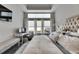 Spacious main bedroom featuring a workstation, sitting area, and large windows at 5318 Wishing Arch Dr, Apollo Beach, FL 33572