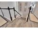 Elegant staircase with dark wood accents and modern design, creating a stylish transition between floors at 5318 Wishing Arch Dr, Apollo Beach, FL 33572