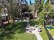Spacious backyard with a fire pit and seating area perfect for outdoor entertaining at 5704 Half Moon Lake Rd, Tampa, FL 33625