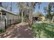 Backyard deck leading to patio under mossy trees, perfect for relaxation at 5704 Half Moon Lake Rd, Tampa, FL 33625