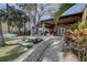 Charming backyard featuring a brick pathway leading to a covered patio and outdoor seating, perfect for entertaining at 5704 Half Moon Lake Rd, Tampa, FL 33625