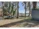 Serene backyard with mature trees, offering a picnic area and views of the waterfront, providing a peaceful retreat at 5704 Half Moon Lake Rd, Tampa, FL 33625