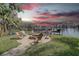 Lakeside backyard with patio seating, firepit and wrought iron fence for outdoor living and entertaining at 5704 Half Moon Lake Rd, Tampa, FL 33625