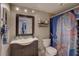 Well-lit bathroom featuring a vanity with a decorative mirror and an octopus themed shower curtain at 5704 Half Moon Lake Rd, Tampa, FL 33625