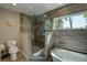 Modern bathroom with a glass shower, separate tub, and stylish fixtures at 5704 Half Moon Lake Rd, Tampa, FL 33625