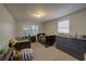 Bright bedroom featuring two beds, with a large dresser with plenty of space, lit by natural light from two windows at 5704 Half Moon Lake Rd, Tampa, FL 33625