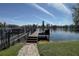 This outdoor view features a well-maintained private dock on a sunny day at 5704 Half Moon Lake Rd, Tampa, FL 33625