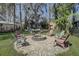 Beautiful backyard gathering spot with a circular firepit and comfortable seating, perfect for outdoor entertainment at 5704 Half Moon Lake Rd, Tampa, FL 33625