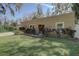 Charming single-story home with mature landscaping, a tan stucco exterior, and updated windows at 5704 Half Moon Lake Rd, Tampa, FL 33625