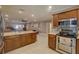 Gourmet kitchen with stainless steel appliances, granite countertops, and a breakfast bar, perfect for gatherings at 5704 Half Moon Lake Rd, Tampa, FL 33625