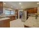 Spacious kitchen with stainless steel appliances, granite countertops, and white tile flooring at 5704 Half Moon Lake Rd, Tampa, FL 33625