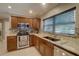 Well-equipped kitchen boasts stainless steel appliances, granite counters, and ample cabinet space at 5704 Half Moon Lake Rd, Tampa, FL 33625