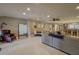 Open-concept living area features tile flooring, a ceiling fan, and ample space for entertaining at 5704 Half Moon Lake Rd, Tampa, FL 33625