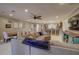 Spacious living area featuring tile floors, a comfortable sectional, and seamless flow to the kitchen at 5704 Half Moon Lake Rd, Tampa, FL 33625