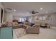 Large sectional sofa in a spacious living room with access to outdoor area and an open floor plan at 5704 Half Moon Lake Rd, Tampa, FL 33625