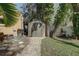 Backyard view of a storage shed with brick pathway, providing practical space and functionality to the property at 5704 Half Moon Lake Rd, Tampa, FL 33625