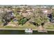 Aerial view of the property with a boat dock, lake access, and boat at 6323 Newtown Cir # 23A1, Tampa, FL 33615