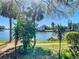 Waterfront backyard features a boat dock and lush landscaping at 6323 Newtown Cir # 23A1, Tampa, FL 33615