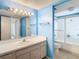 Bright bathroom with a single sink vanity, shower-tub combination, and tiled accents at 6323 Newtown Cir # 23A1, Tampa, FL 33615