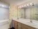 Bathroom features a double sink vanity, large mirror, and a shower/tub combo at 6323 Newtown Cir # 23A1, Tampa, FL 33615