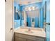 Blue bathroom featuring a vanity with a sink and a large mirror at 6323 Newtown Cir # 23A1, Tampa, FL 33615