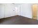 Bedroom with neutral walls, carpeted floors, and open door to hallway at 6323 Newtown Cir # 23A1, Tampa, FL 33615