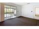 Bedroom featuring carpeted floors and sliding glass doors to balcony overlooking a water view at 6323 Newtown Cir # 23A1, Tampa, FL 33615